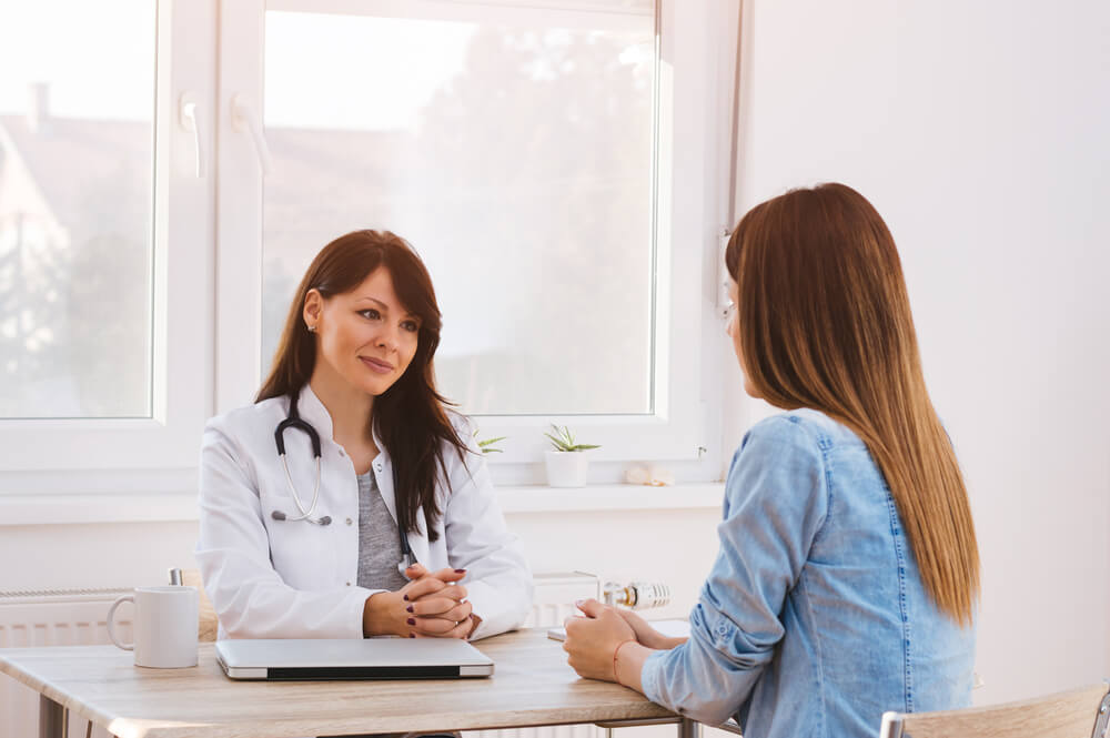 Doctor and Patient in Office Talking.