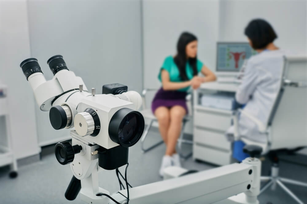 Colposcope Close-up Over Gynecological Consultation of Woman Patient With Doctor Gynecologist