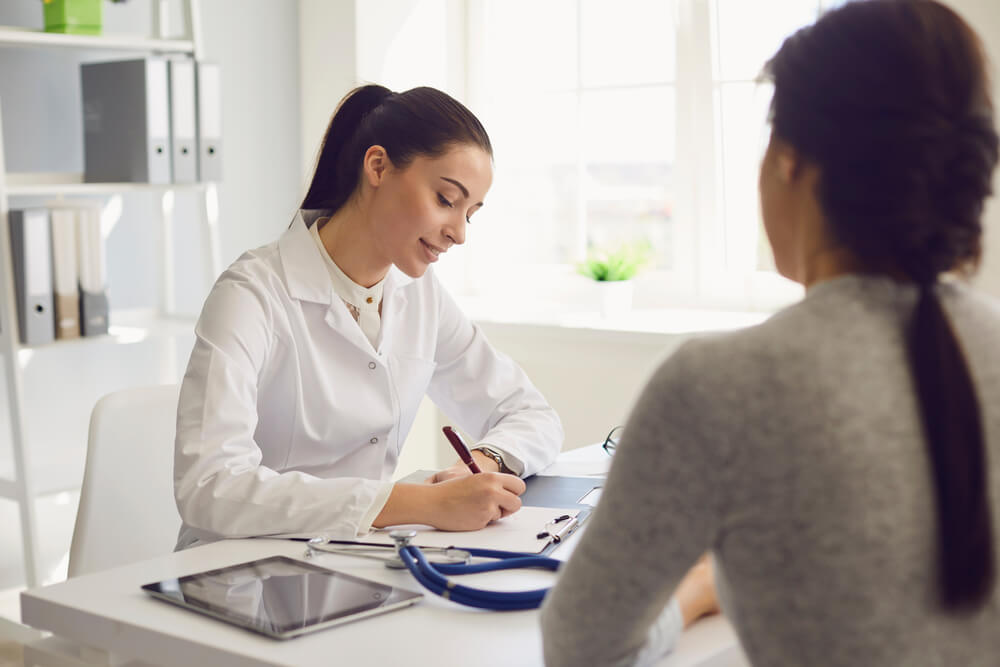 Woman Patient Visiting Female Doctor at Clinic Office