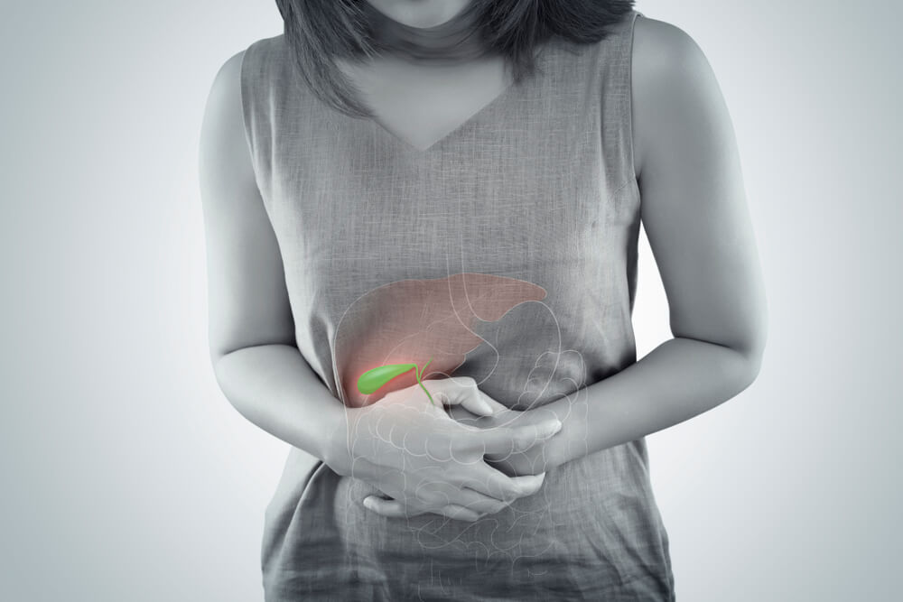 Woman Holding Stomach Because of Gallbladder Pain