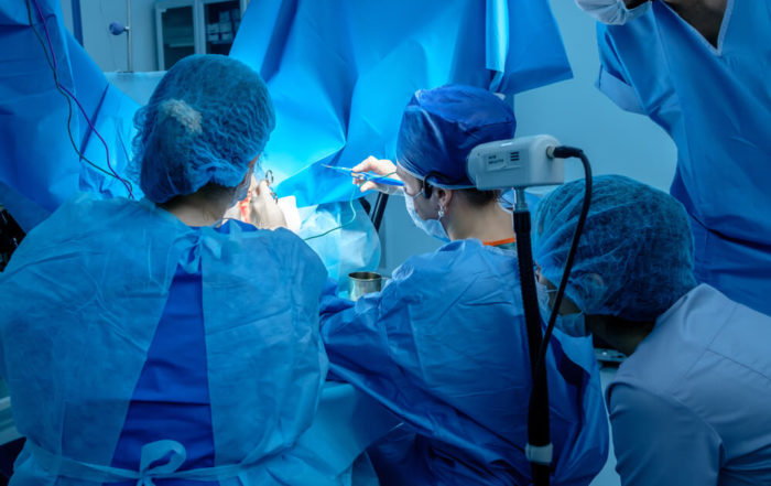 A Group of Surgeons Performing Minimally Invasive Surgery on the Patient’s Anus Using Surgical Instruments.