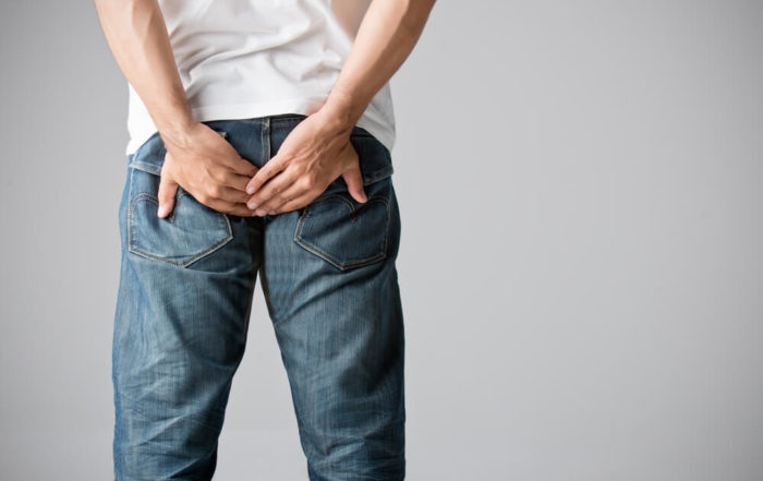 Man Holding His Bottom in Pain