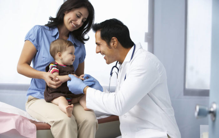 Doctor In Surgery Examining Baby Girl