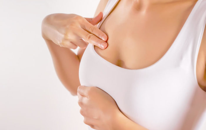 Woman Wearing a White Tank Top Checking Her Breast, Breast Self-Exam