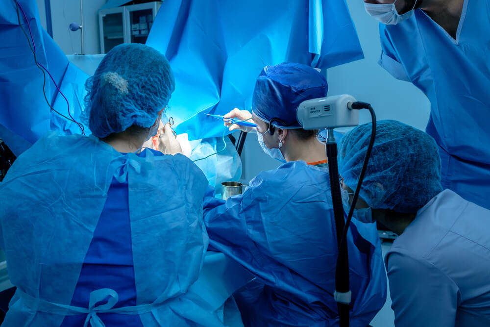 A Group of Surgeons Performing Minimally Invasive Surgery on the Patient’s Anus Using Surgical Instruments