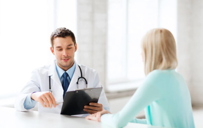 Healthcare and Medical Concept - Male Doctor With Patient in Hospital