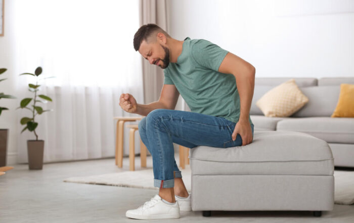 Man Suffering From Hemorrhoid in Living Room