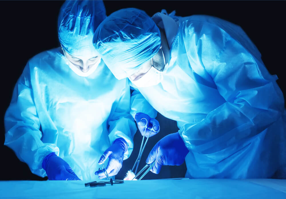 Two Surgeons, a Man and a Woman, Perform Surgery