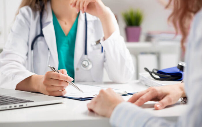 Doctor consulting patient, hands closeup.