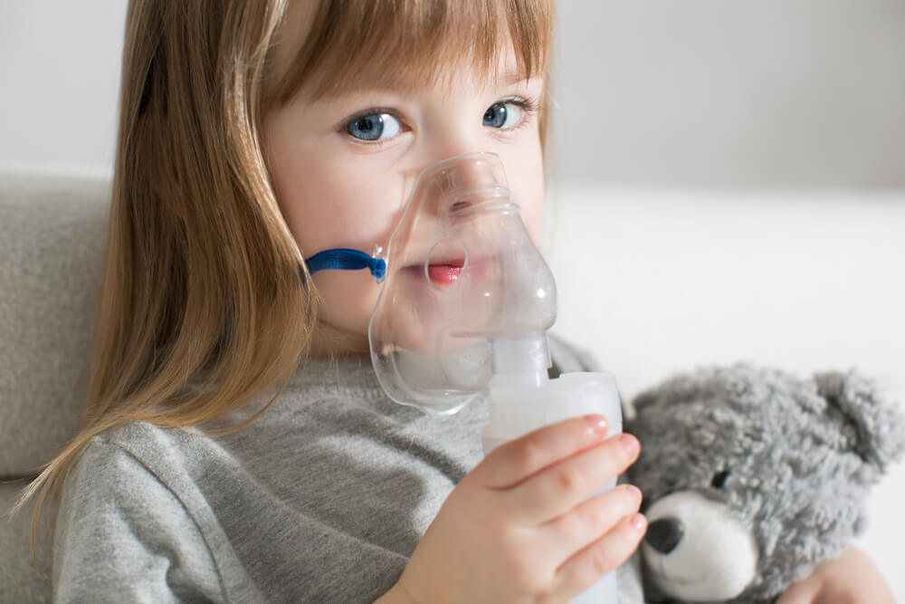 Little Girl Making Inhalation With Nebulizer at Home