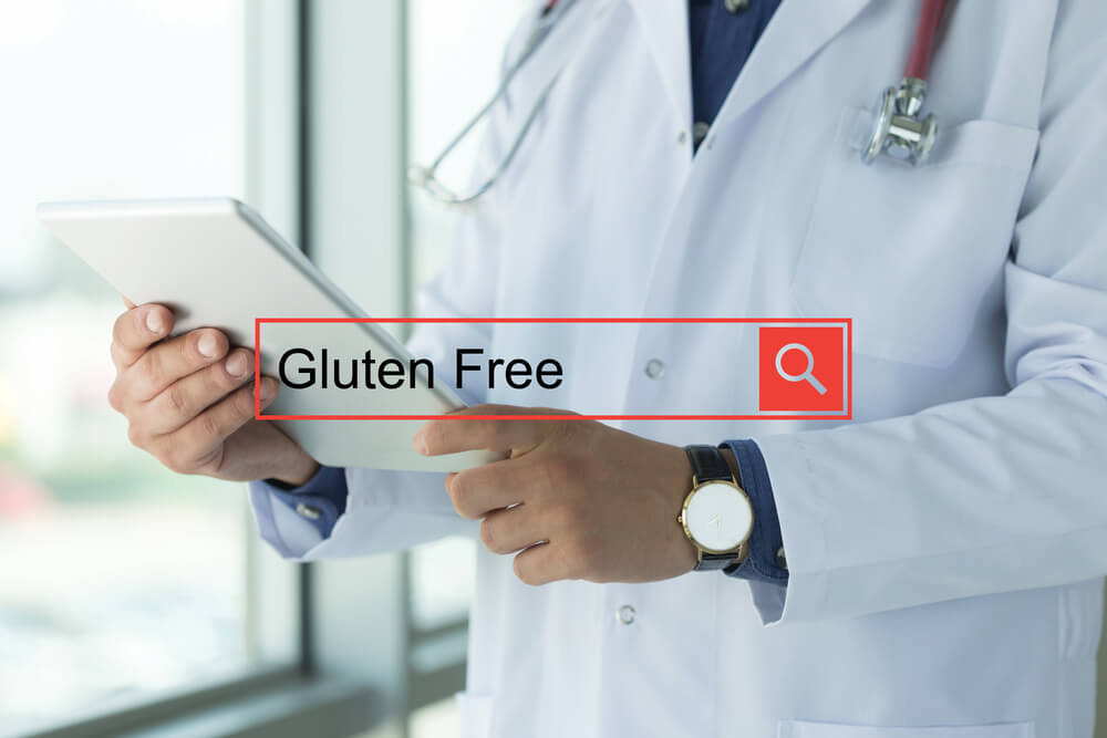Doctor Using Tablet PC Searching Gluten Free on Web
