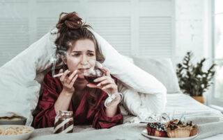 A Depressed Woman Smoking in the Bed and Drinking Wine