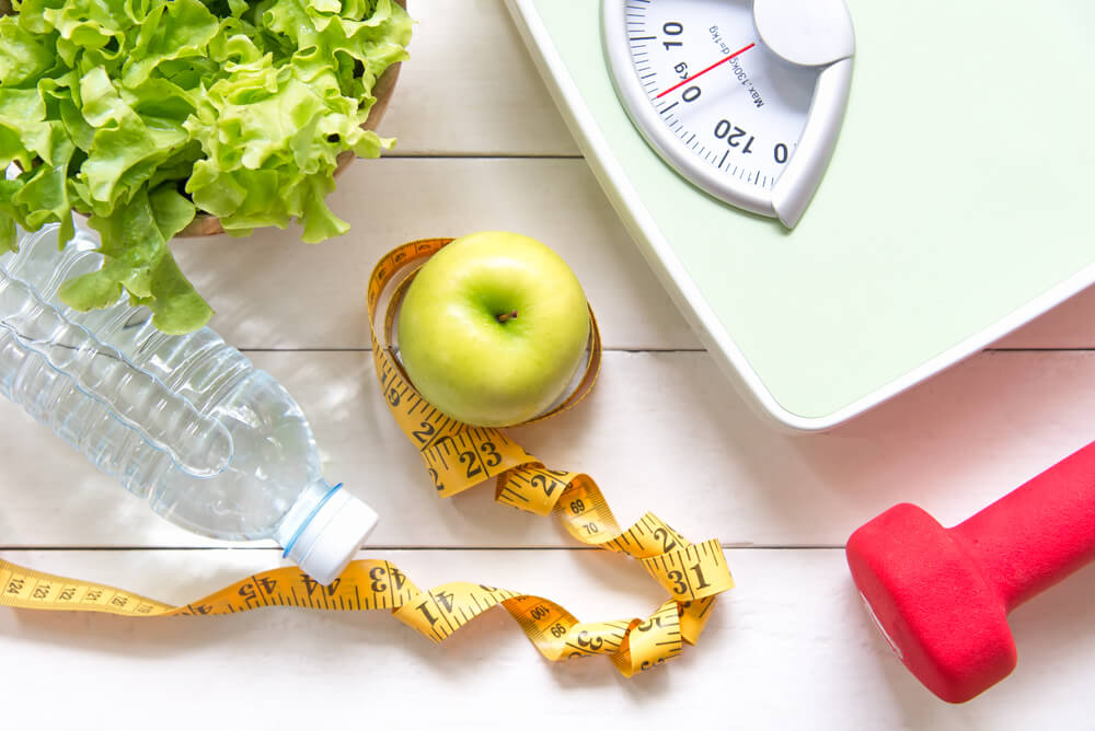 Diet and Healthy Life Concept. Green Apple and Weight Scale,Measure Tap With Fresh Vegetable, Clean Water and Sport Equipment for Women Diet Slimming.