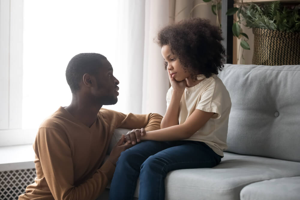 Father Talking With Upset Preschooler Daughter