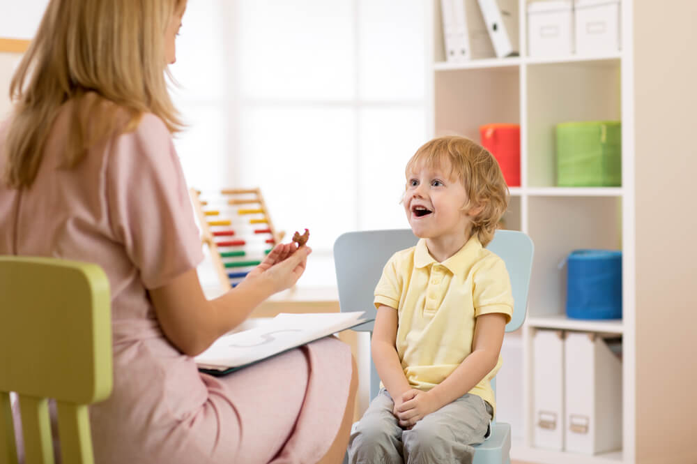 Psychologist Working With Child Boy in Office