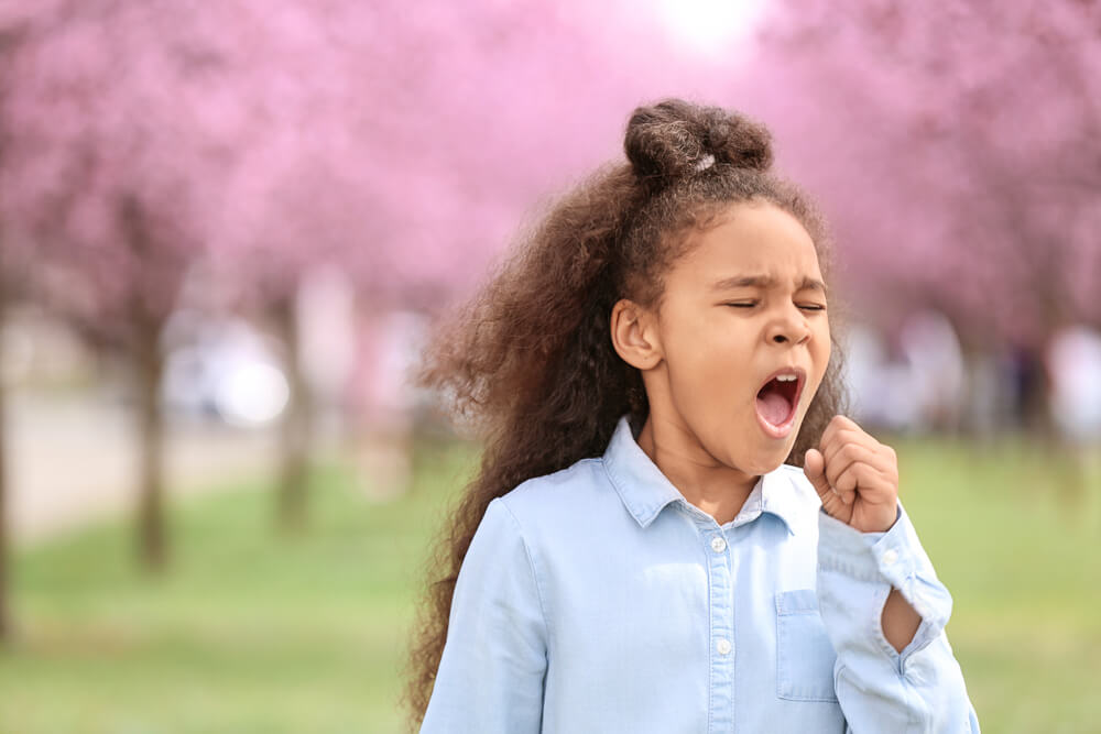 African-American Girl Having Asthma Attack Outdoors on Spring Day