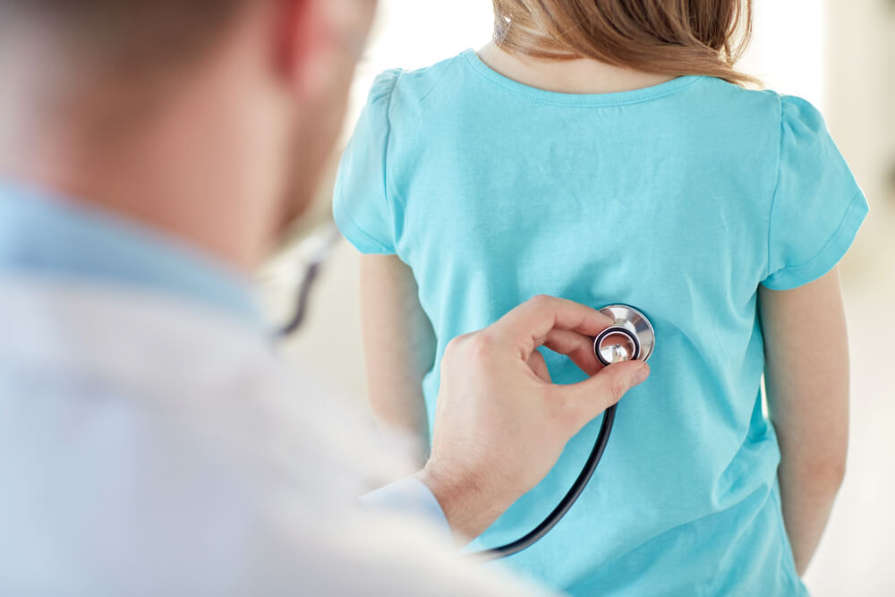 Girl and Doctor With Stethoscope Listening to Heartbeat