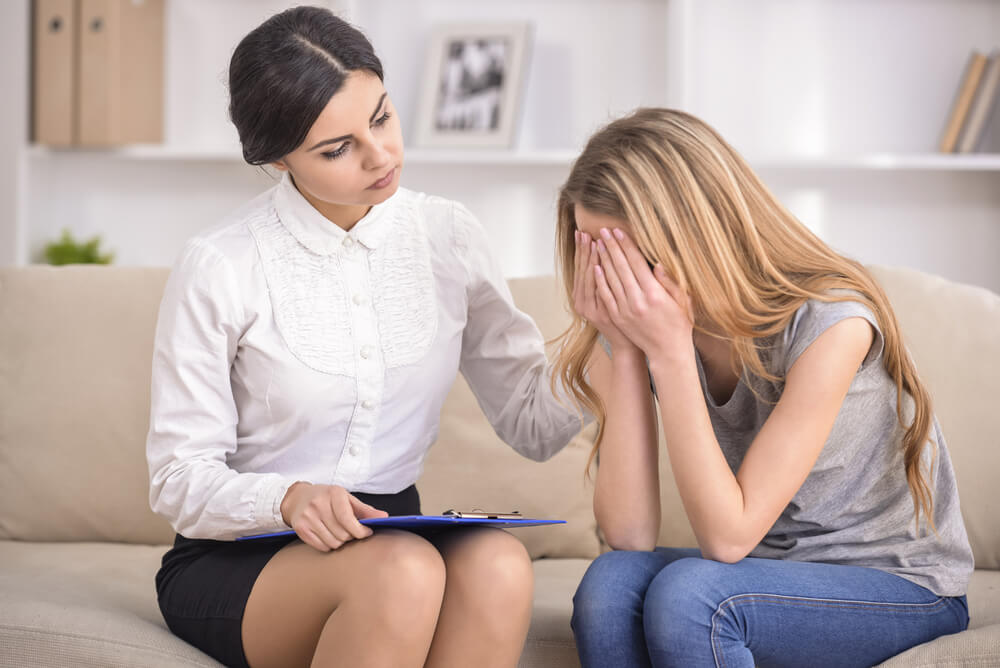 The Reception at Psychologist Comforting a Patient at Office.