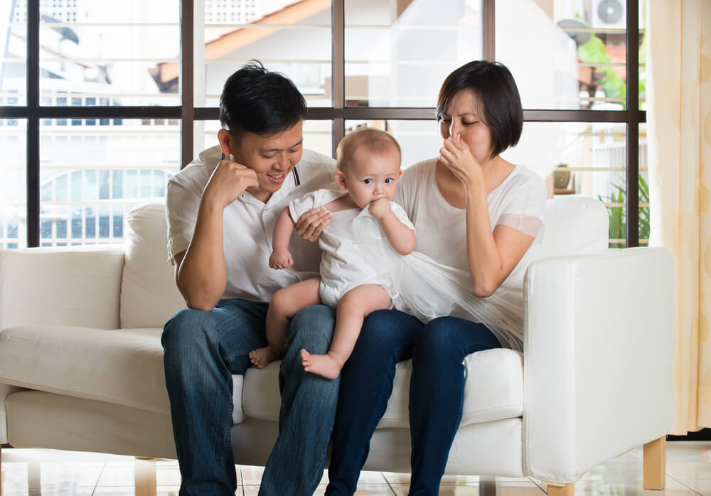 Asian Parent With Smelly Baby Diaper