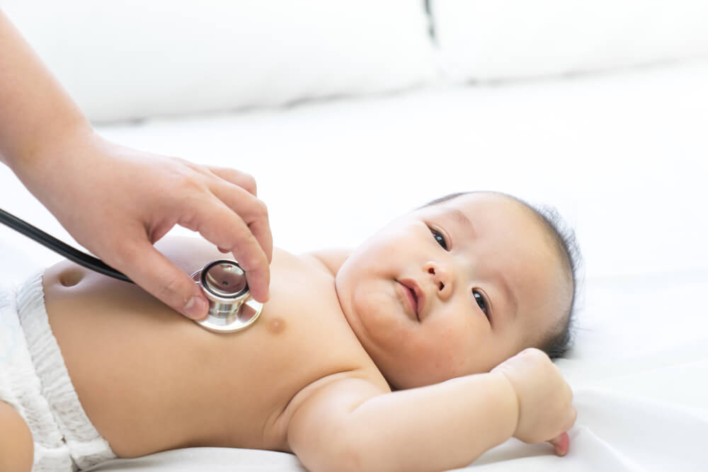 Doctor Exams Asian Newborn Baby With Stethoscope in the Hospital