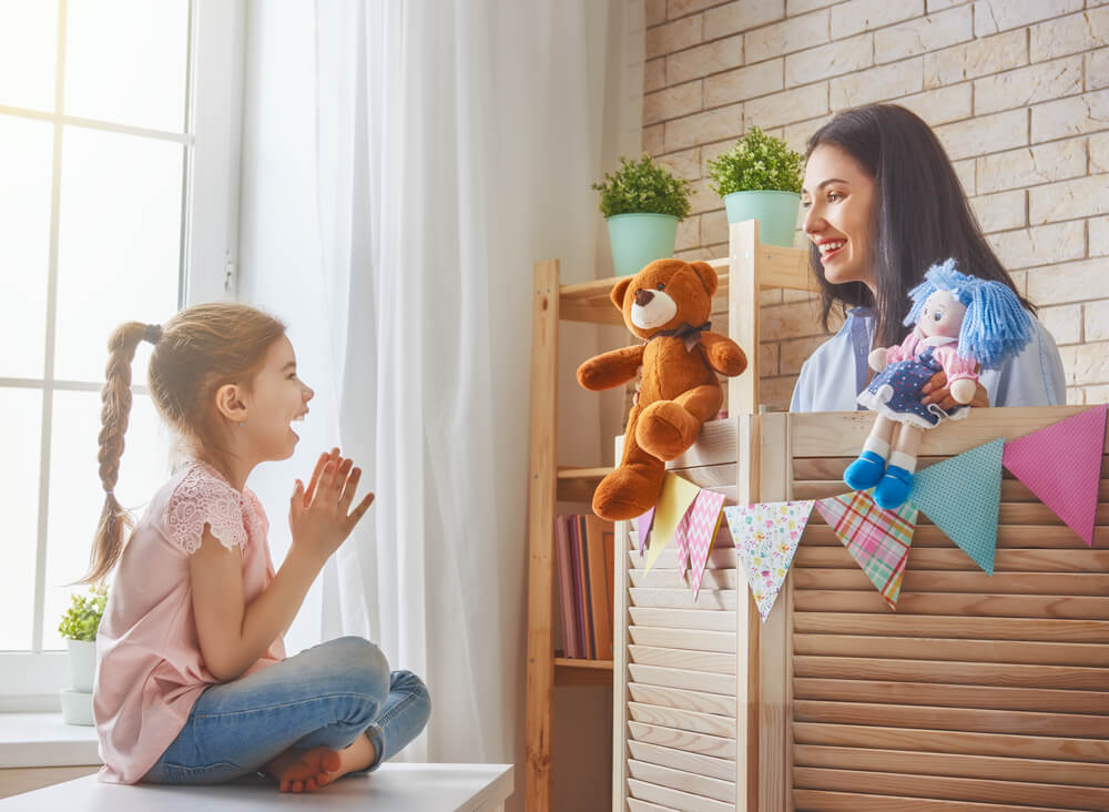 Funny Mom and Lovely Child Having Fun and Playing Performance in the Puppet Theater Indoors