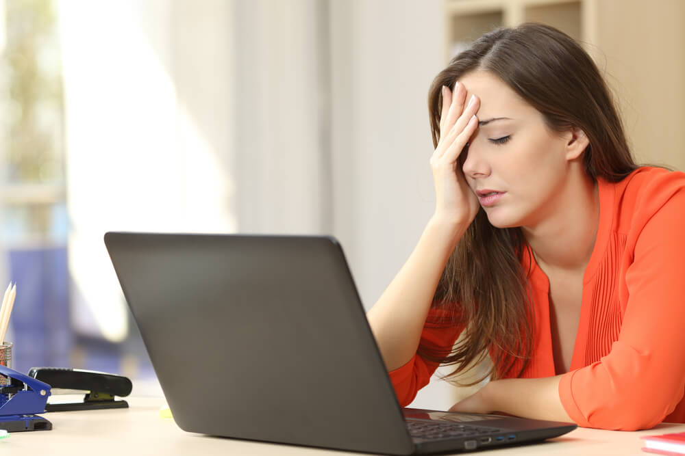 Tired Overworked Freelancer Working With a Laptop in an Office or Home
