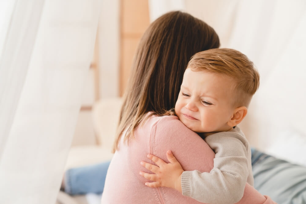 Caucasian Mother Lulling Cradling Her Crying Little Small Son Daughter Toddler Infant Newborn Baby.