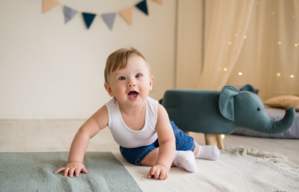 Caucasian Baby Boy Crawls on the Floor in the Children’s Room With Toys. Happy Childhood