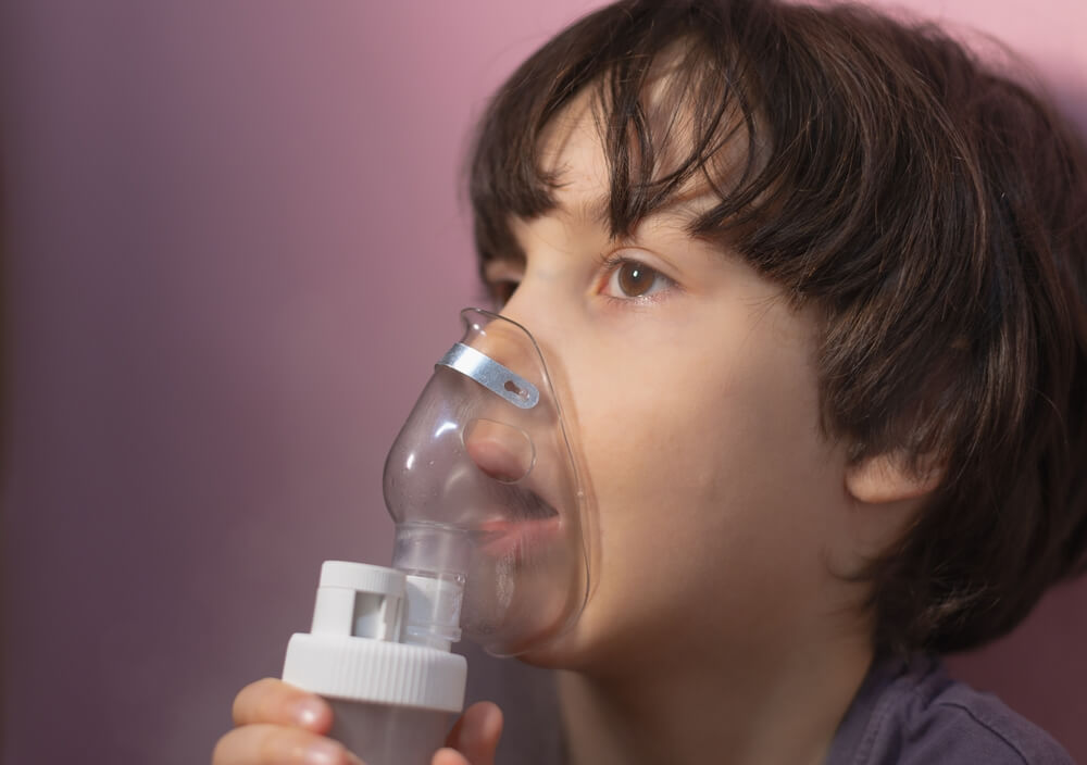 The Child Does Inhalation, The Boy Inhales The Medicine Through The Mask, Nebulizer Mask, Treatment Of The Disease