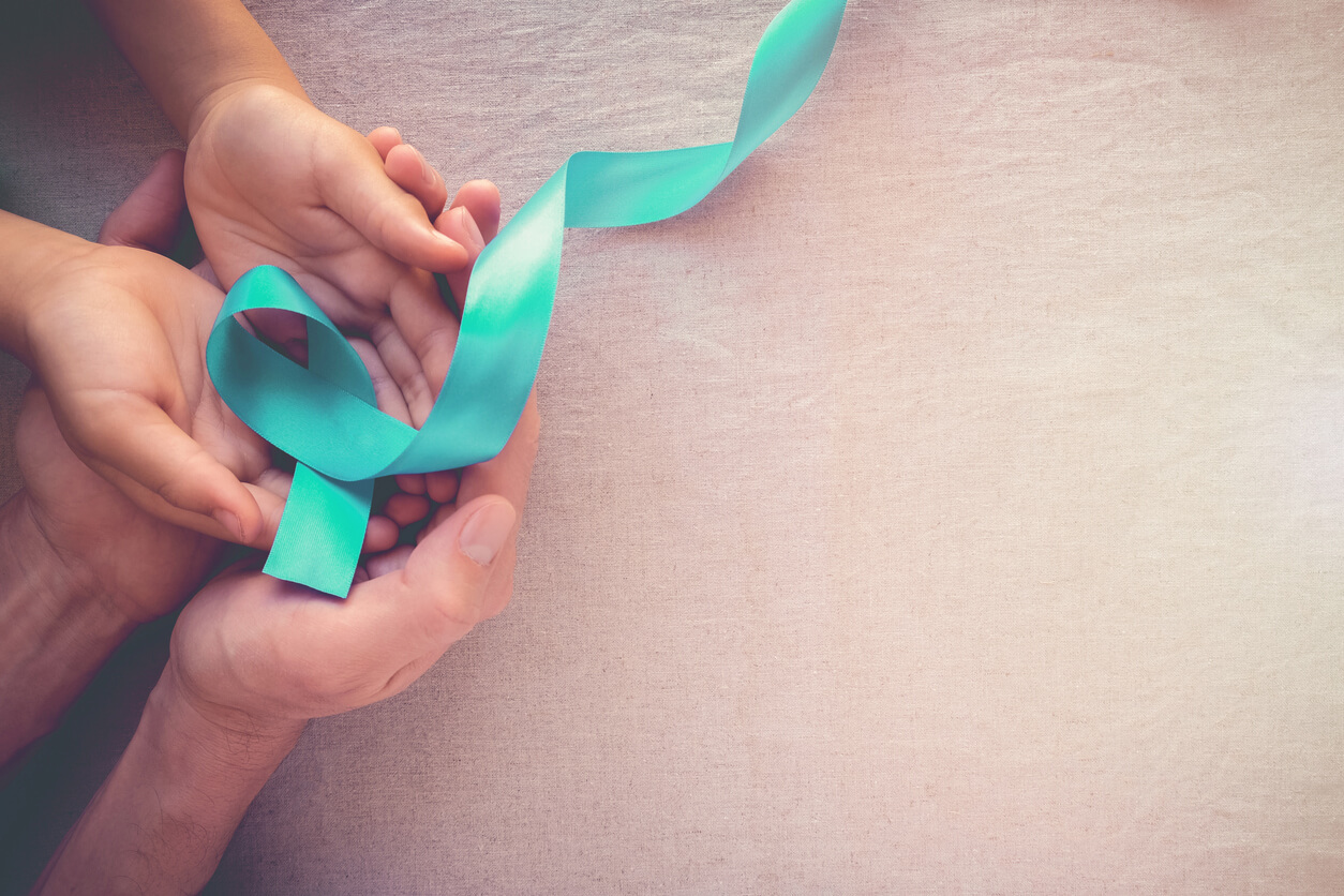 Adult and Child Hands Holding Teal Ribbon