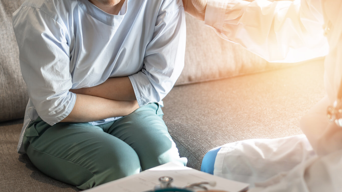 Woman Having Abdominal Pain and Holding Her Stomach