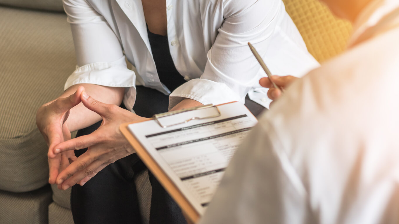 Woman Patient With Doctor or Psychiatrist Consulting