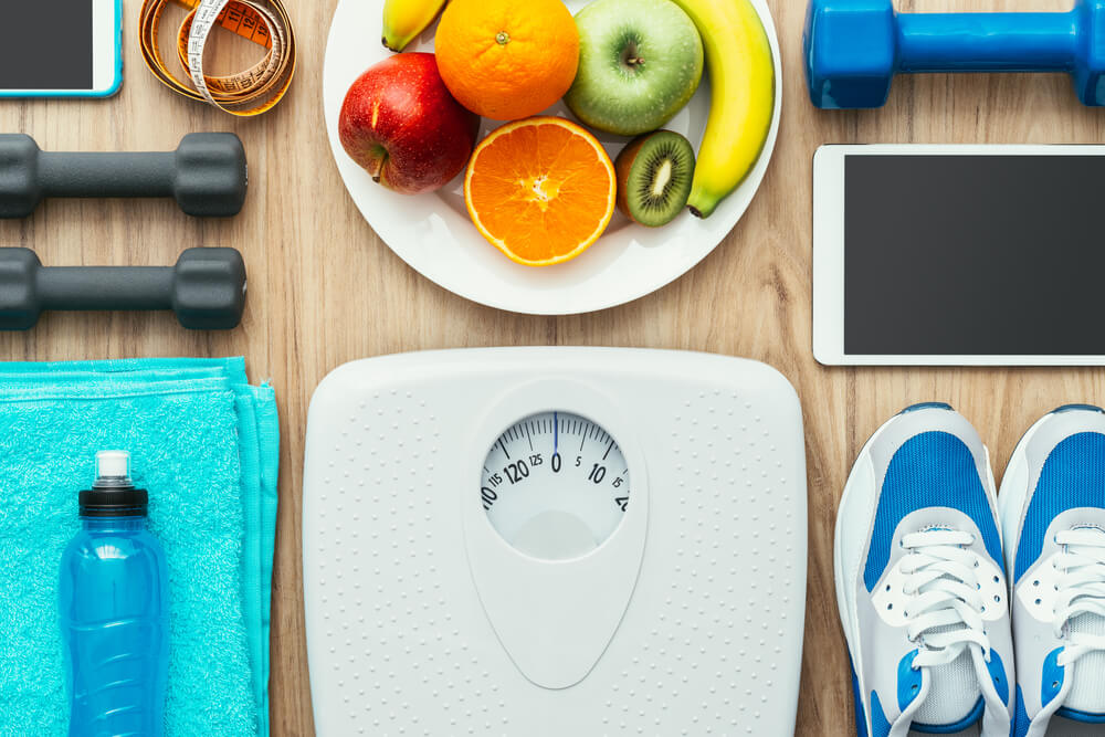 Sports and Workout Equipment, Digital Tablet and Fruit on a Wooden Table