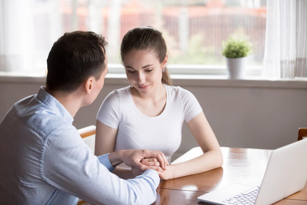 Loving Man Holding Woman Hands Looking At Her Showing Love and Understanding