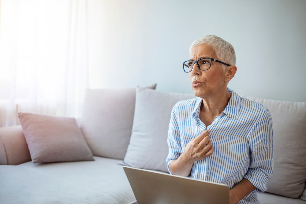 Mature Woman Experiencing Hot Flush From Menopause