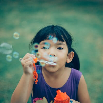 girl blowing bubbles