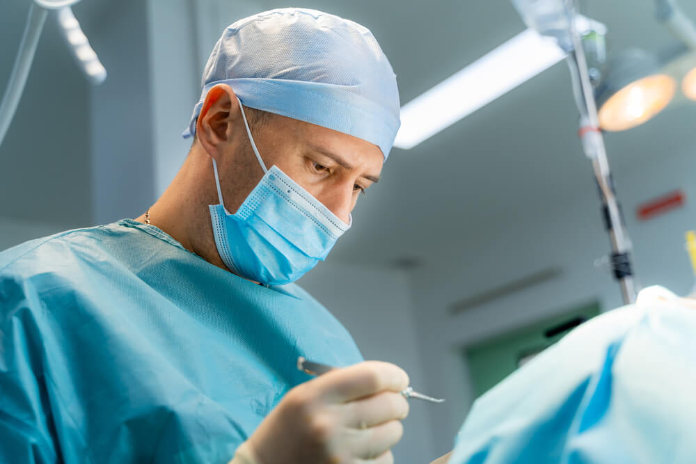 Surgeon Is Performing Surgery in Hospital Operating Room