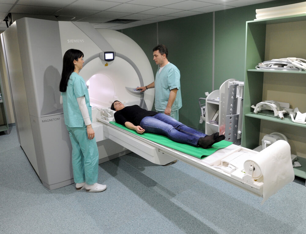 Doctor Showing Magnetic Resonance Exam Procedure