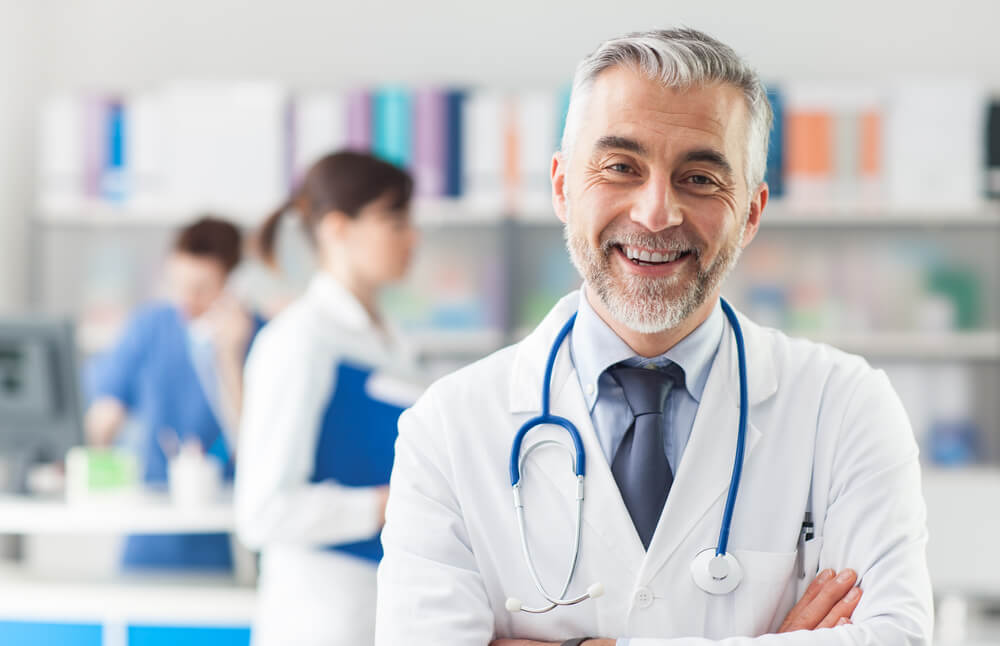 Smiling doctor posing with arms crossed in the office