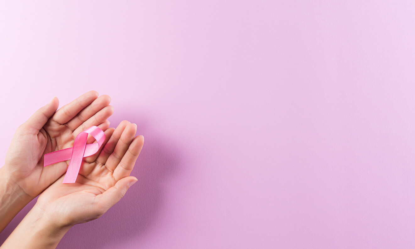 Hands Holding Pink Ribbons, Breast Cancer Awareness, Symbolic Bow Color Raising Awareness on Women's Breast Tumor.