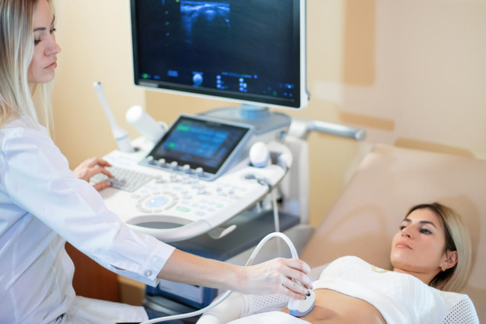 Woman Doctor Conducts an Ultrasound Study of the Patient.