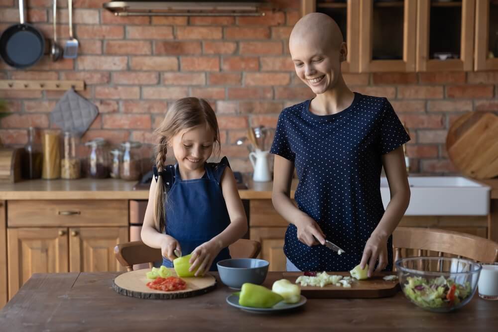 Happy Daughter Child Helping Cancer Patient Mom to Cook Dinner