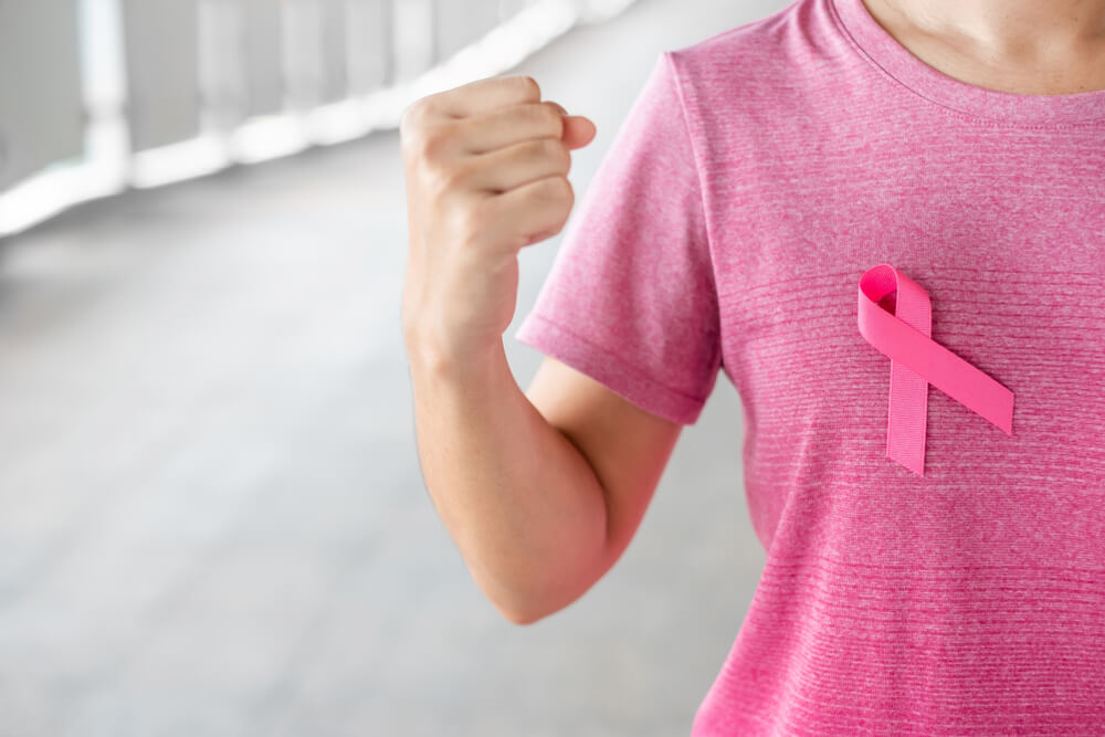 October Breast Cancer Awareness Month, Woman in Pink T- Shirt With Pink Ribbon for Supporting People Living and Illness.