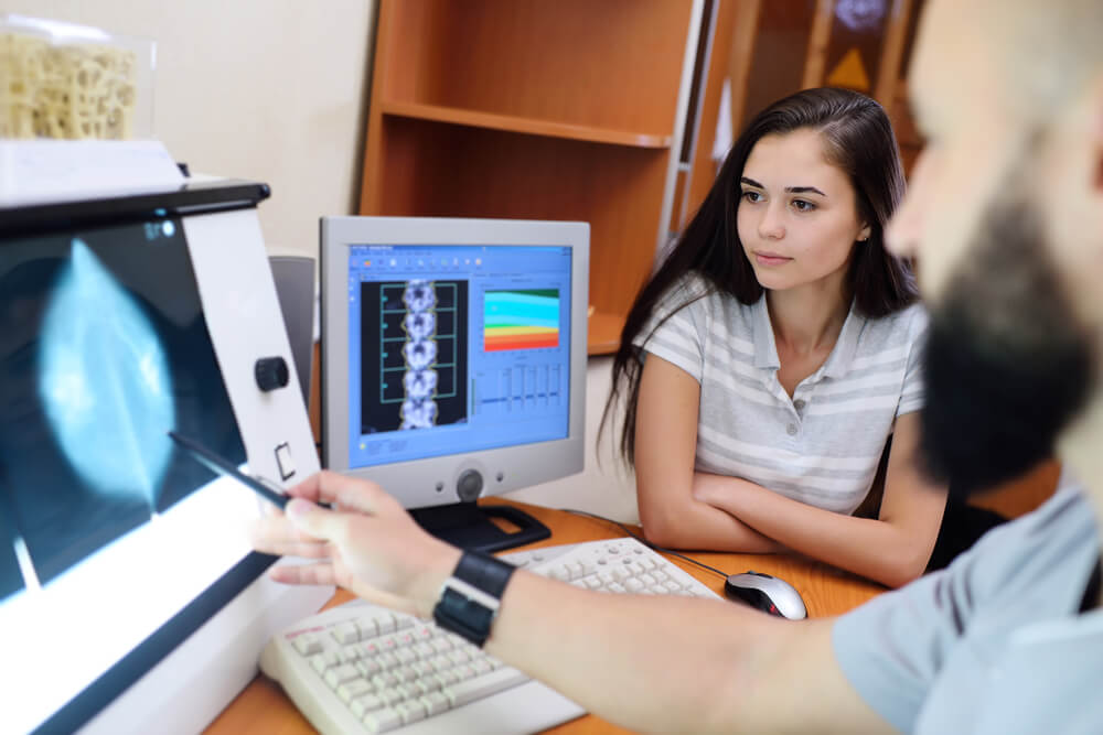 The Doctor and the Patient Are Watching a Mammogram