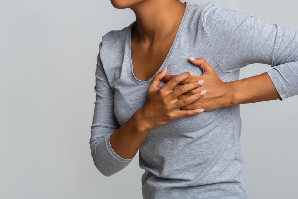 Young African Woman Feeling Menstrual Cyclic Breast Pain, Touching Her Chest, Close Up