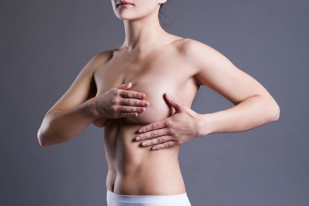 Woman Examining Her Breasts for Cancer,