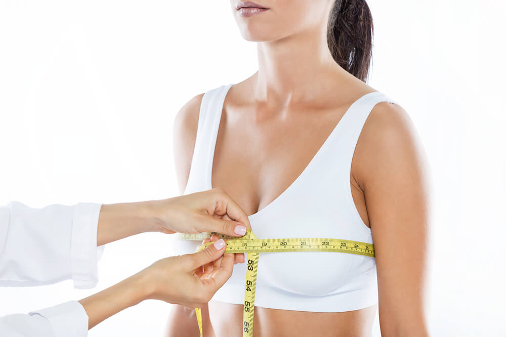 Portrait of Doctor With Measure Tape Measuring the Size of the Patient’s Breast.