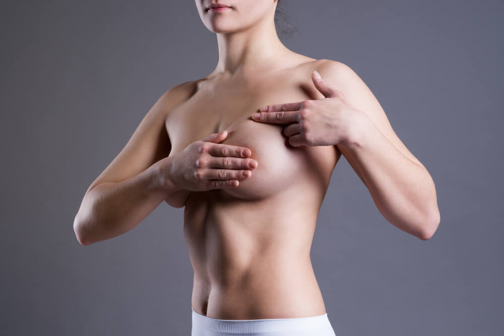 Woman Examining Her Breasts for Cancer, Pain on Female Body