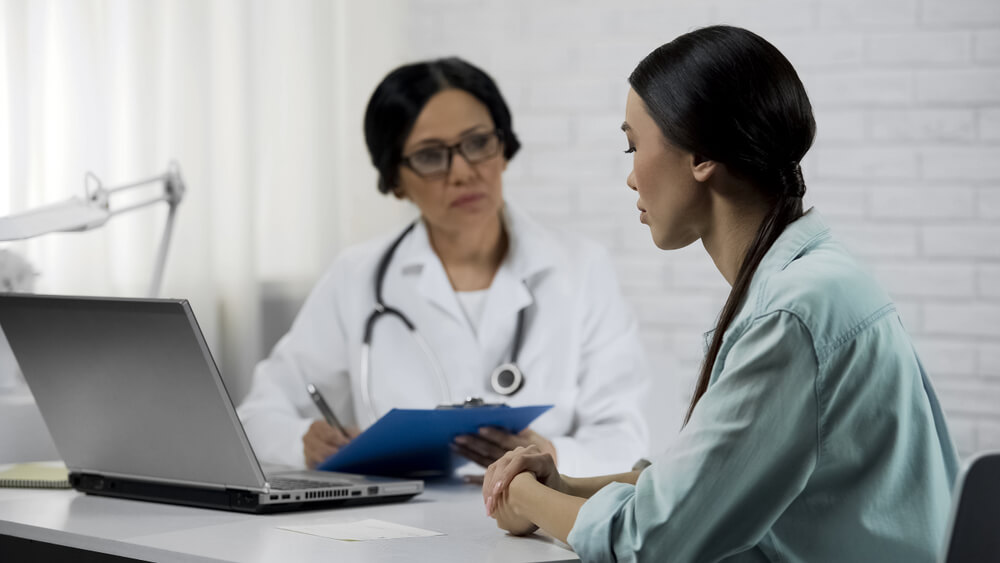 Woman Listening Doctors Advice of Treatment