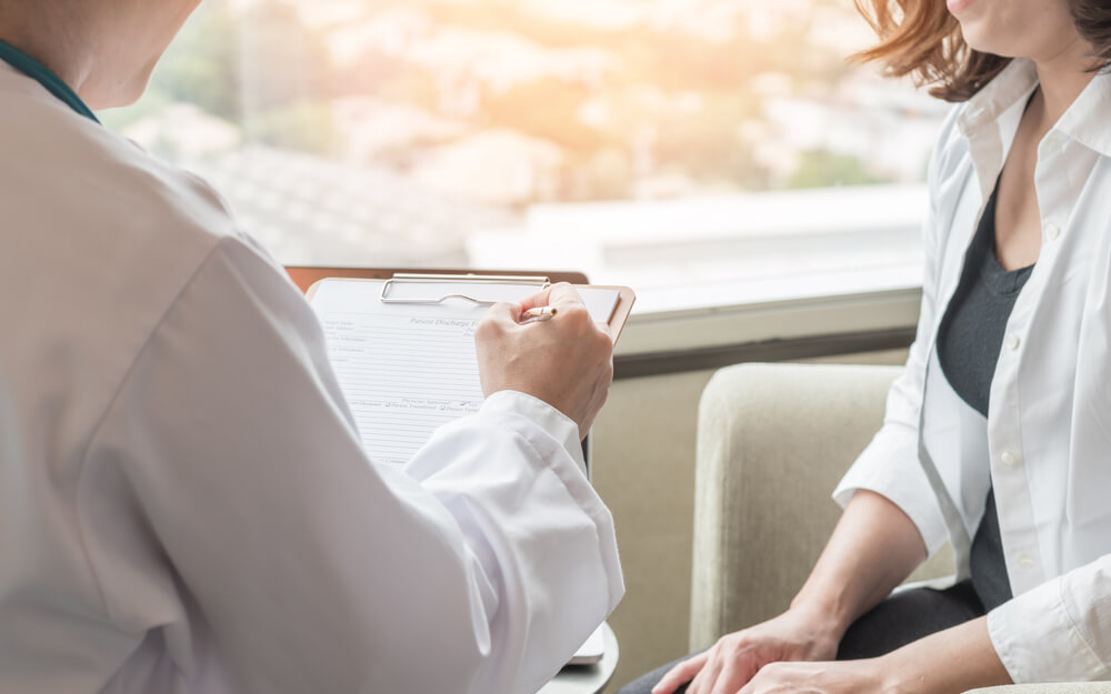 Woman Consulting Doctor